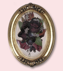 red roses from wedding preserved in a gold frame