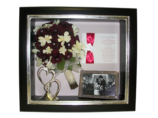 preserved wedding bouquet of red and white roses with memorabilia in black frame with silver lip