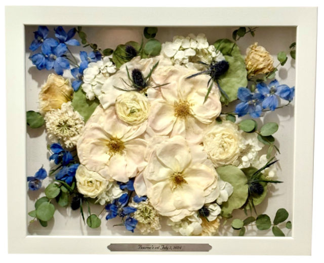 white and blue pressed flowers in white square frame